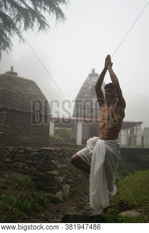Young Man With Shredded Body Wearing Dhoti, Praying In The Temple Early In The Morning.
