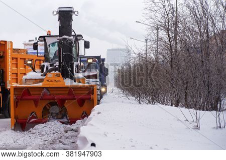 Norilsk, Russia - March 23, 2020: Snow Removal Machine, Road Cleaning Vehicle, Snow Plow Doing Snow 