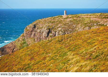 Scenic View Of Cape Frehel And Its Lighthouse, One Of The Most Popular Tourist Destinations In Britt