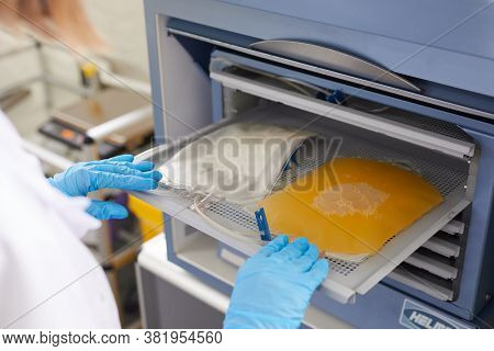 Close-up Of Nurse In Protective Gloves Working In The Laboratory With Blood Plazma