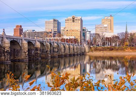 Harrisburg, Pennsylvania, USA skyline on the Susquehanna River with fall foliage.