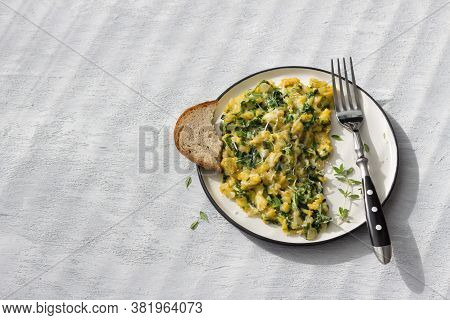 Scrumble Eggs With Kale And Cheese On A Light Gray Background, Top View. Delicious Homemade Breakfas