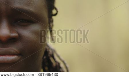 Half Face Of An African Crying Black Man With A Tear In The Eye. High Quality Photo
