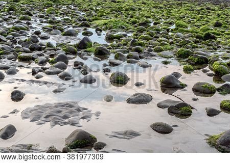 Extreme Low Tide On The Ventura Coast Exposed Tide Pools Reflect Overhead Clouds In The Sky.