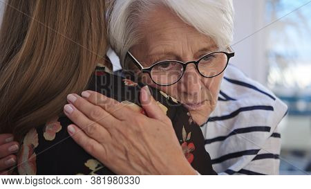 Young Woman Embracing An Elderly Lady. Grief And Bead News, Empathy Concept. High Quality 4k Footage