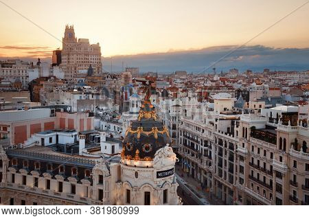 MADRID, SPAIN â MAY 13, 2019: Telefonica Building and historical buildings in business district rooftop view at sunset.
