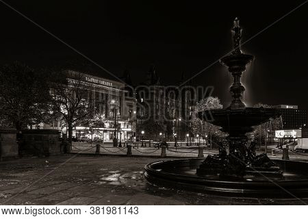 LIVERPOOL, UK - FEB 23, 2020: Liverpool Walker Art Gallery fountain historical buildings closeup view at night in England in United Kingdom