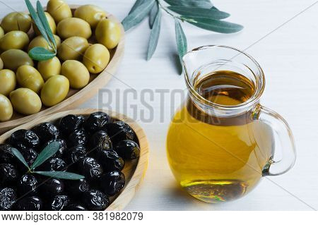 Glass Bottle Of Homemade Olive Oil And Olive Tree Branch, Raw Turkish Green Olive Seeds And Leaves O