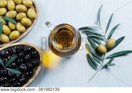 Glass Bottle Of Homemade Olive Oil And Olive Tree Branch, Raw Turkish Green Olive Seeds And Leaves O