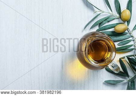 Glass Bottle Of Homemade Olive Oil And Olive Tree Branch, Raw Turkish Green Olive Seeds And Leaves O
