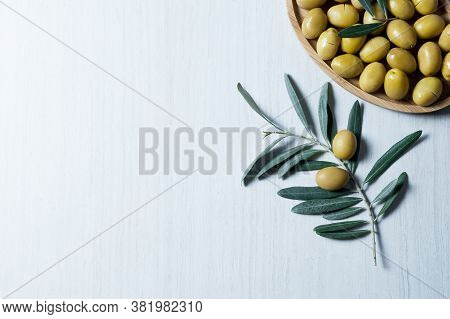 Raw Turkish Green Olive Seeds, Olive Tree Branch With Leaves On White Table. Olives Background, Oliv
