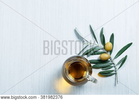 Glass Bottle Of Homemade Olive Oil And Olive Tree Branch, Raw Turkish Green Olive Seeds And Leaves O