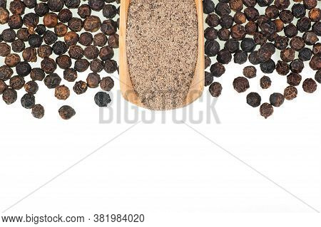 Close Up Heap Of Black Pepper In Wooden Spoon, Peppercorns And Milled Pepper Powder Isolated On Whit