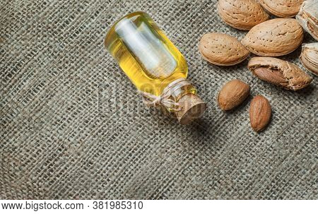 Sweet Almond Oil In Glass Of Bottle. Almonds Nuts And Oil Concept.great For Skin Health.almond In Nu