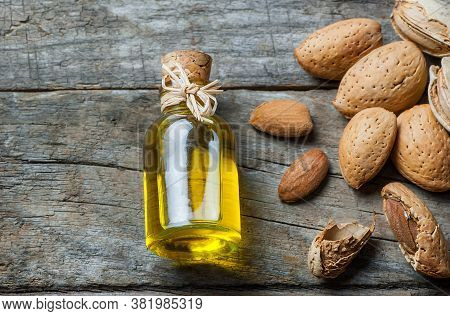 Sweet Almond Oil In Glass Of Bottle. Almonds Nuts And Oil Concept.great For Skin Health.almond In Nu