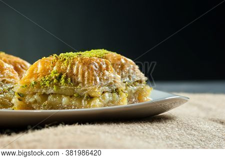 Traditional Turkish Dessert Antep Baklava With Pistachio On White Plate. Desserts Concept