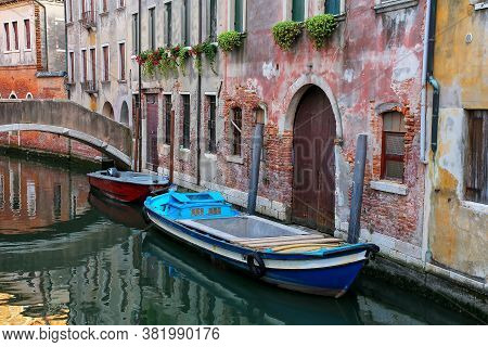 Boats Moored In A Narrow Canal In Venice, Italy. Venice Is Situated Across A Group Of 117 Small Isla