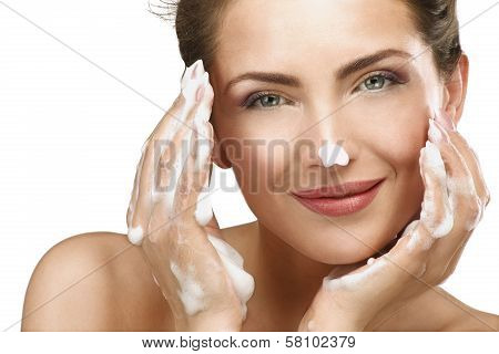 Beautiful Woman Cleaning Her Face With A Foam Treatment