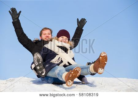 Young Happy Couple Sledging
