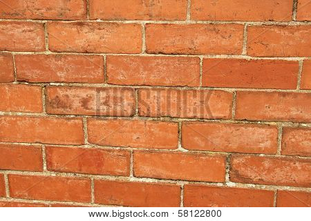 Textured detail of worn brick wall