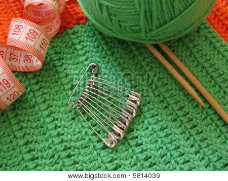 Green clew and needle for knitting