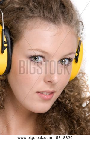 Beautifil girl in yellow protective headphones