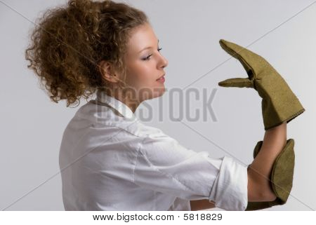 Beautiful girl playing with protective gloves