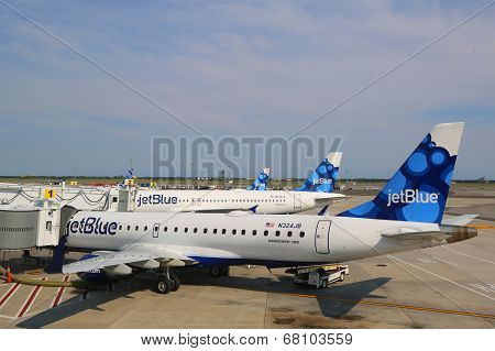 JetBlue Airbus A320 and  Embraer 190 aircraft at the gates at the Terminal 5 at JFK Airport