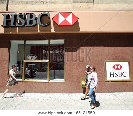 NEW YORK CITY - FRIDAY, JUNE 20, 2014:   Pedestrians walk past a HSBC bank in Manhattan on Friday, June 20, 2014. HSBC Holdings plc is a British multinational banking and financial services company