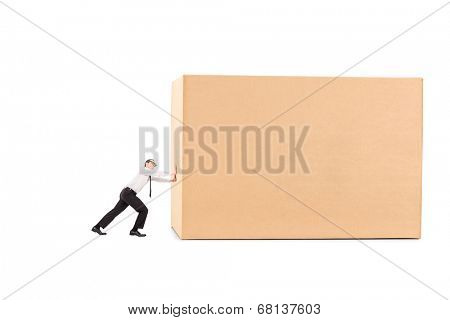 Determined businessman pushing a huge box isolated on white background