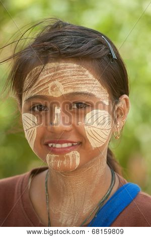 Woman With Thanaka On Her Face In Myanmar.