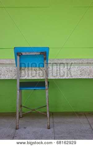 Blue Student's Chair Beside Green Bright Wall