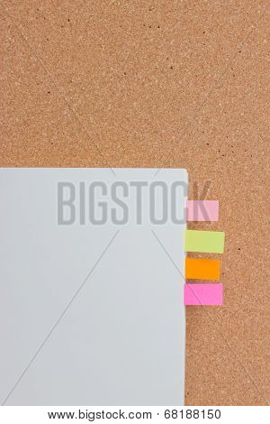 Sticking Reminder On Notepad With Corkboard.