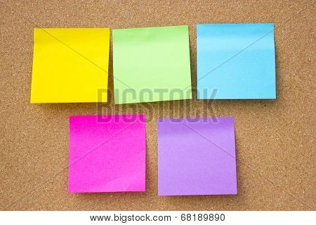 Wooden Board With Five Blank Colorful Sticky Notes.