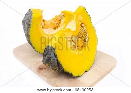 Punpkins on chopping block isolated on white background.