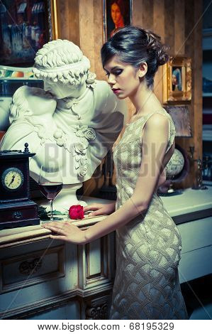 Beautiful woman in white lace dress in vintage scenery. Portrait of young brunette