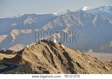 Ancient Casttle On Cliff Among High Mountains And Green Valley