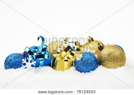 Blue And Golden Christmas Decoration On Snow In Line