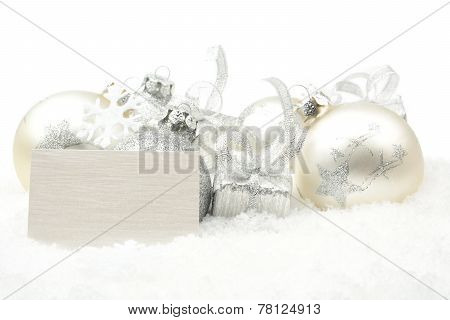 Silver Christmas Decoration On Snow With Wishes Card In Line