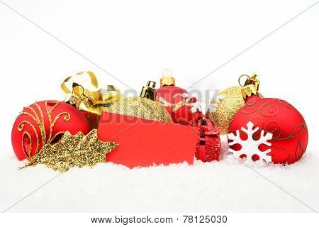 Golden,red Christmas Decoration On Snow With Wishes Card
