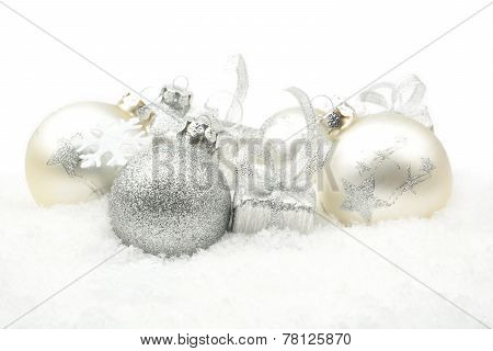 Silver Christmas Decoration On Snow In Line