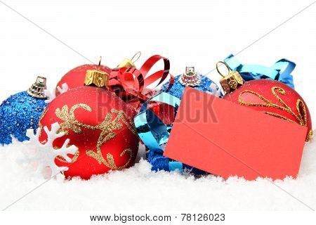 Group Of Red,blue Christmas Decoration With Wishes Card On Snow