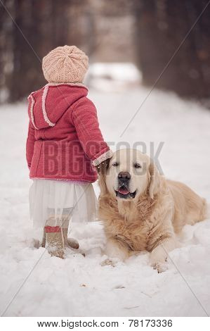 Little girl with dog at winter park
