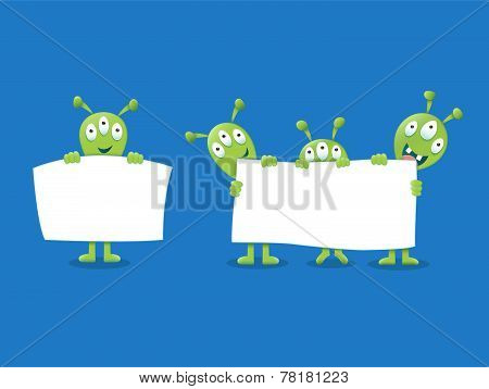 Cute Aliens holding a white sign