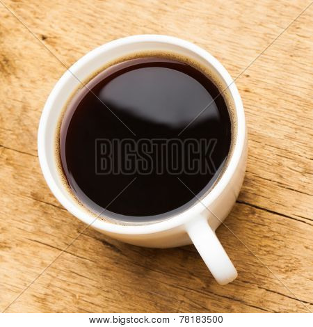 Coffee In White Ceramic Cup On Wooden Table - View From Top