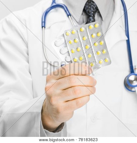 Doctor Holdling Pills In His Hand