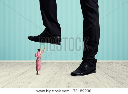 angry woman in pink dressing gown looking up and screaming at big man