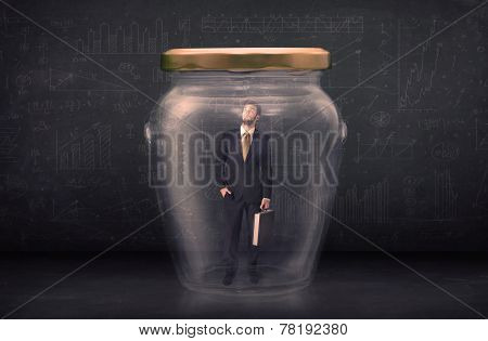 Business man closed into a glass jar concept on background