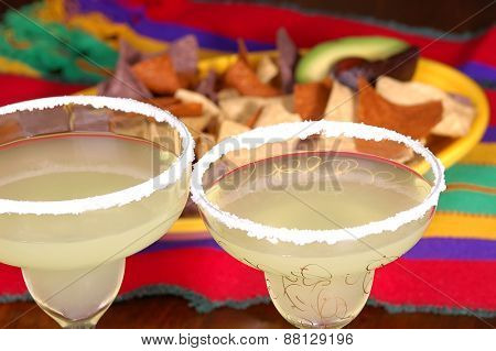 Margaritas with platter of corn chips on Mexican table cloth. Ready for a Cinco de Mayo project.