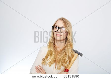girl with a hammer and nerd glasses. isolated on white